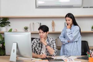 UX and UI Collaboration. Two designers discussing project ideas in a creative workspace. photo