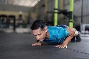 Man Engaged in Push-Up Exercise at Gym photo