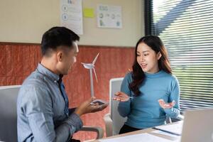 ESG Initiative Discussion. Two colleagues sharing ideas on sustainable business practices. photo