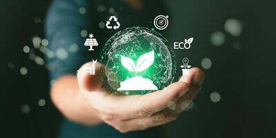 Green Business Innovation and Sustainable Development concept. man hold world to save energy,and reduce global warming,climate change,ecology friendly investment,ESG environment social governance. photo