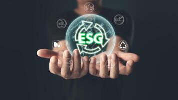 The glowing ESG icon symbolizes commitment to environmental, social,and governance principles,emphasizing sustainability,ethical practices,and eco-friendly solutions for a balanced,responsible future. photo