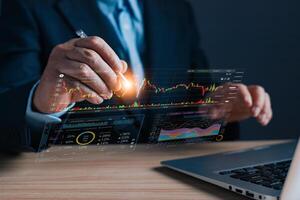 A professional analyzes a digital marketing plan using advanced charts and data graphs on a laptop, showcasing modern strategies, trends, and performance insights for decision making. photo