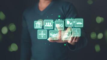man touch screen to save energy,and reduce global warming,climate change,ecology friendly investment,ESG environment social governance,Green Business Innovation and Sustainable Development concept. photo