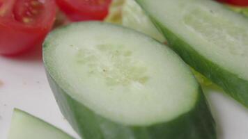 Fresh cucumber slices ready for salad preparation video