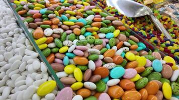 Colorful candy display at a market during daylight hours video