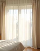 Serene Bedroom with Sheer Curtains photo