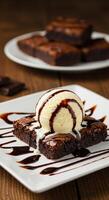 Delicious brownie dessert topped with vanilla ice cream and chocolate sauce photo