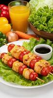 Delicious grilled chicken skewers with fresh vegetables and orange juice a healthy meal photo