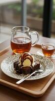 Delicious brownie dessert with ice cream and chocolate sauce served with tea photo
