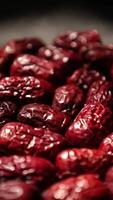 a close up of dried dates on a black surface video