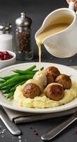 Delicious Meatballs in Creamy Gravy served with Mashed Potatoes and Green Beans photo