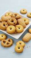 Delicious assorted butter cookies arranged on a plate and table, perfect for a sweet treat or snack photo