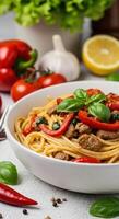 Delicious Spaghetti with Meat Sauce, Tomatoes, and Basil in a Bowl photo