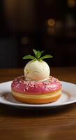 Delicious Pink Donut Topped with Vanilla Ice Cream and Mint photo