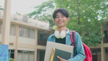 Smiling Asian University Student with Headphones on Campus video