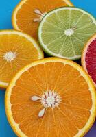 Juice-Droplet Covered Citrus Slices on Color-Splashed Background photo