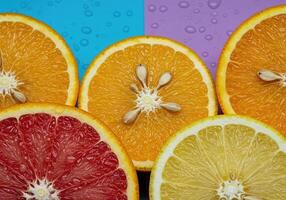 Juicy Lemon and Orange Cross Sections with Seeds on a Lively Background photo