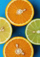 Freshly Cut Orange and Lemon Citrus Halves on Bright Colorful Backdrop photo