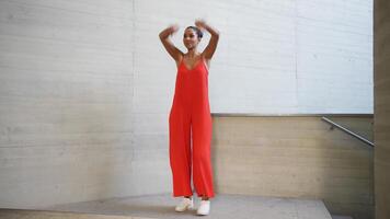 An Elegant Woman in a Stunning Red Dress Posing Gracefully at Modern Architecture Background video
