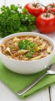 Delicious Lentil Soup Recipe with Pasta and Fresh Herbs in a Bowl photo