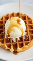 Delicious Waffles topped with Vanilla Ice Cream and Caramel Sauce photo