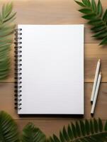 A blank notebook surrounded by nature awakens creativity in a serene workspace. photo