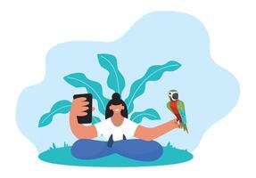 Young woman holding a smartphone and a parrot sitting in a lotus position on grass with large leaves behind her, enjoying a moment of connection with nature and technology vector