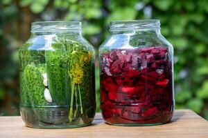 Jars Of Pickled Cucumbers And Beetroots photo