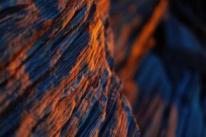 Intriguing close up of a textured rock formation, displaying an interplay of light and shadow. photo