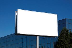 An empty billboard in the city, waiting for advertisements. Modern office buildings and the sky is in the background. photo