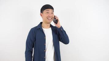 Man talking mobile phone have a good news feeling happy show fits up smile face on white background indoor video