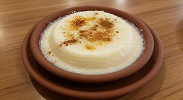 A bowl of pudding with cinnamon on top photo