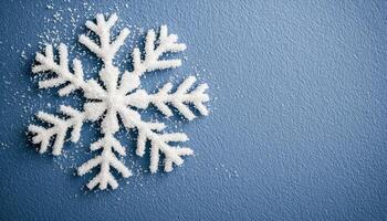 Snowflake crystal texture on cold surface studio setting high-quality image blue background photo