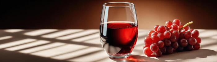 Elegant glass of red wine on plain table warm tone soft lighting captivating still life photo