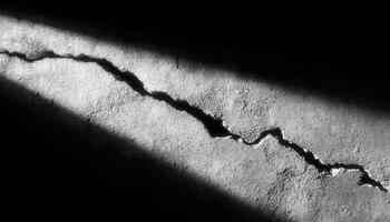 Dramatic cracks in broken cement wall surface urban environment high-contrast photography photo