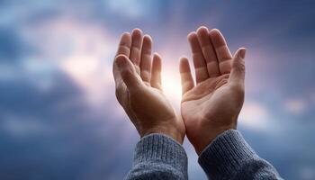 Hands raised in prayer against soft cloudy sky spiritual reflection tranquil environment photo