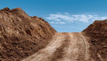 Tire tracks on loose earth heap in dry ground landscape natural environment aerial view photo