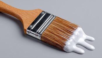 White paint dripping from brush on clean background close-up shot artistic environment photo