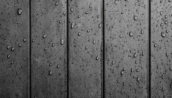 Subtle rain drops on grey cement wall texture urban environment close-up photography photo