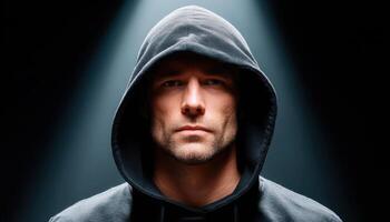 Dramatic portrait of a hooded man studio lighting cinematic style strong contrast photo