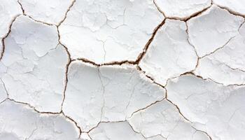 Cracked and dried salt flat surface under bright sunlight desert natural landscape aerial view photo