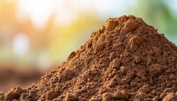 Mound of brown soil in natural light at construction site earthy texture outdoor view photo