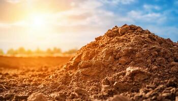 Freshly dug soil pile in open construction ground at sunset earthy landscape photography photo