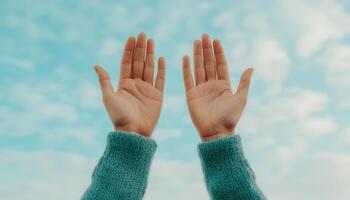 Hands raised in prayer against soft cloudy sky low resolution spiritual reflection photo