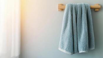 Rustic bathroom decor fluffy cotton towel hanging on hook in soft light environment photo