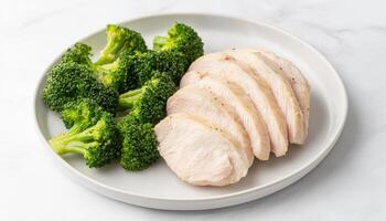 Healthy meal prep steamed broccoli and boiled chicken in clean food photography photo