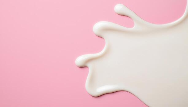 Flowing white condensed milk stream on pastel pink background visual art low resolution photo
