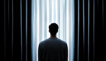 Solitary reflection dark room emotional portrait soft morning light rear view introspection photo