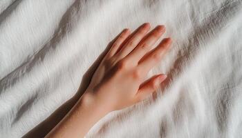 Gentle touch of hand on soft fabric indoor setting closeup photography natural light photo