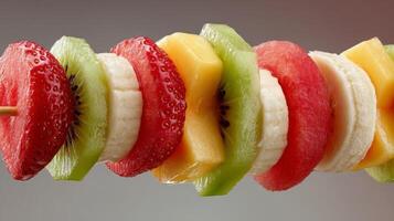 Colorful Fruit Skewer with Strawberries, Kiwi, Banana and Mango photo